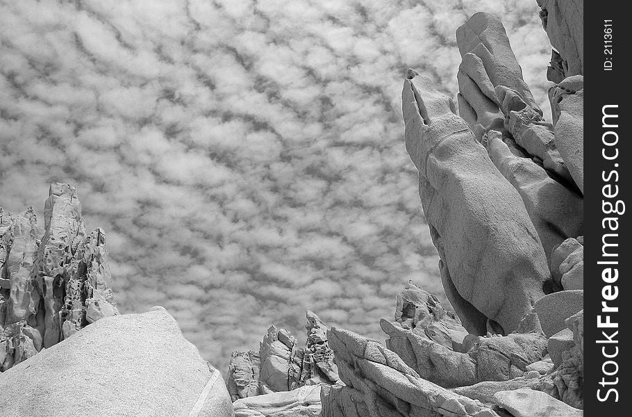 Rocks of many different formations with a background of a cloudy sky in Cabo San Lucas, Mexico. Rocks of many different formations with a background of a cloudy sky in Cabo San Lucas, Mexico.