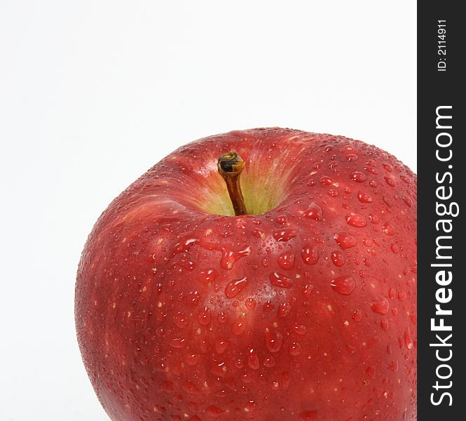 Red apple with drops on white background