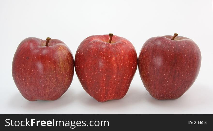 Three red apples on white background