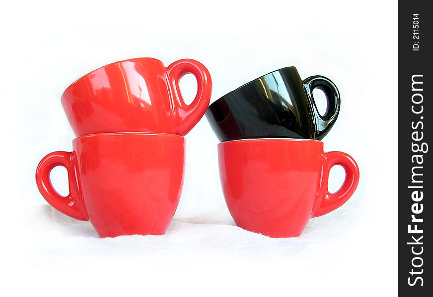 Tree red and one black cups over white isolated. Tree red and one black cups over white isolated