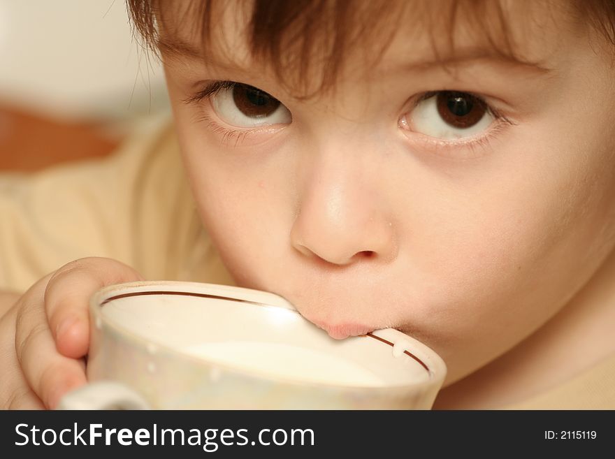 Sight of the boy which drinks milk from a cup