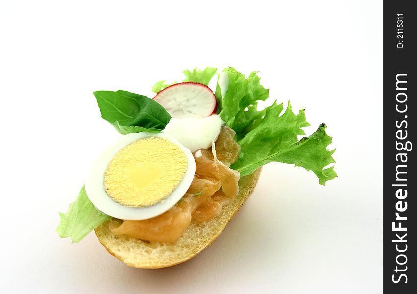 Fresh sandwich with salmon, egg, iceberg lettuce, piece of basil, radish and tzatziki. Fresh sandwich with salmon, egg, iceberg lettuce, piece of basil, radish and tzatziki