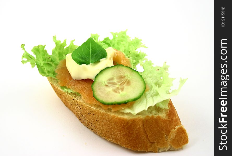 Fresh sandwich with salmon, cucumber, iceberg lettuce piece of basil and mayonnaise. Fresh sandwich with salmon, cucumber, iceberg lettuce piece of basil and mayonnaise