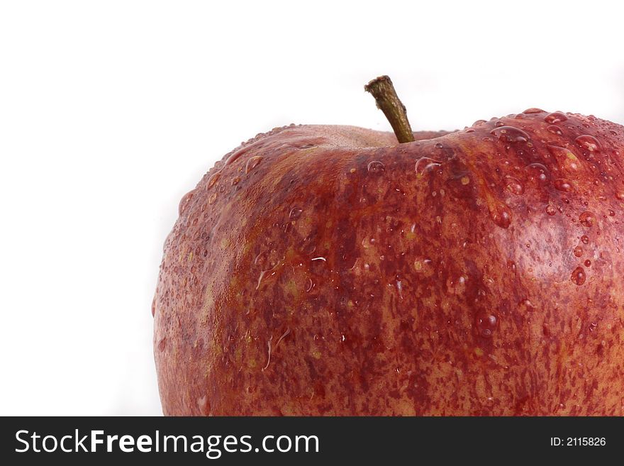 A delicious red apple with waterdrops over 100 % white background. A delicious red apple with waterdrops over 100 % white background.