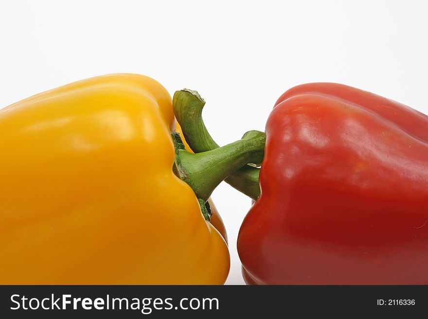 Yellow and red peppers on white background