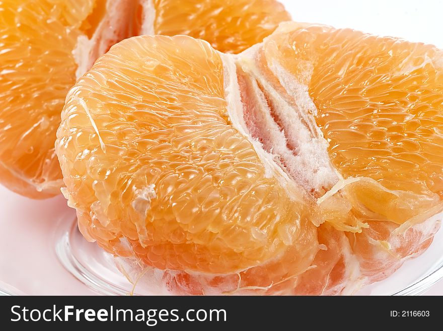 Half of juicy pink grapefruit on a glass plate. Half of juicy pink grapefruit on a glass plate