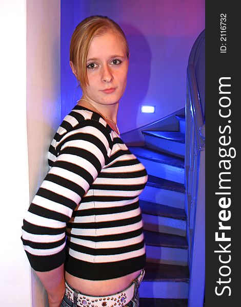 Young lady posing in striped jumper on coloured background. Young lady posing in striped jumper on coloured background