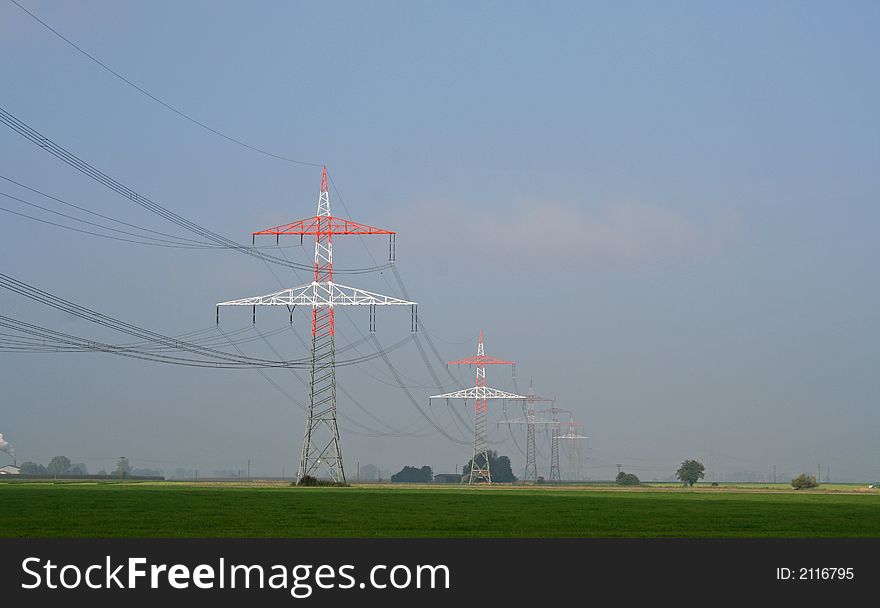 Red and white electricity pylons. Red and white electricity pylons