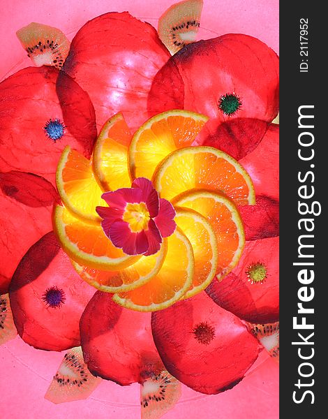 Arrangement of slices of beetroot and orange with a flower in the middle. Some pieces of kiwi on the outsinde. Arrangement of slices of beetroot and orange with a flower in the middle. Some pieces of kiwi on the outsinde