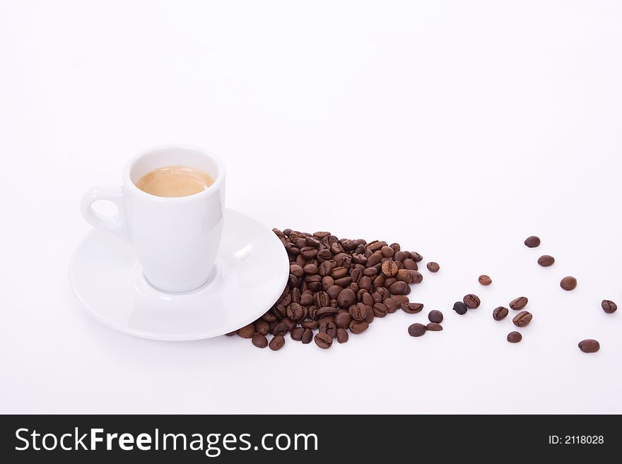 Coffee cup and coffee beans over white background. Coffee cup and coffee beans over white background
