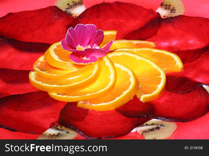 Arrangement of slices of beetroot and orange, a flower in the center. Arrangement of slices of beetroot and orange, a flower in the center.