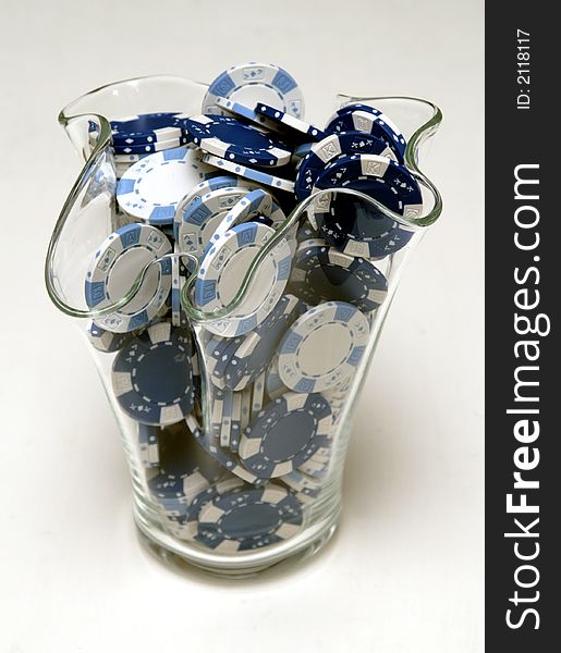 Blue and white Poker Chips in a vase.