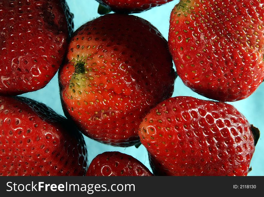 Close-up image of strawberries on blue background. Close-up image of strawberries on blue background