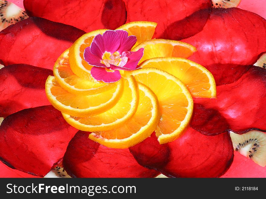 Arrangement of slices beetroot and orange, with flower in the center taken at an angle o app. 70 deg. Arrangement of slices beetroot and orange, with flower in the center taken at an angle o app. 70 deg.