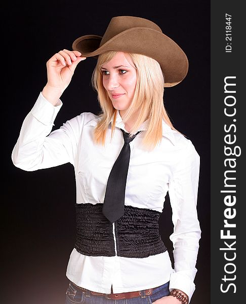 Beautiful sexy blonde cowgirl in studio with cowboy hat