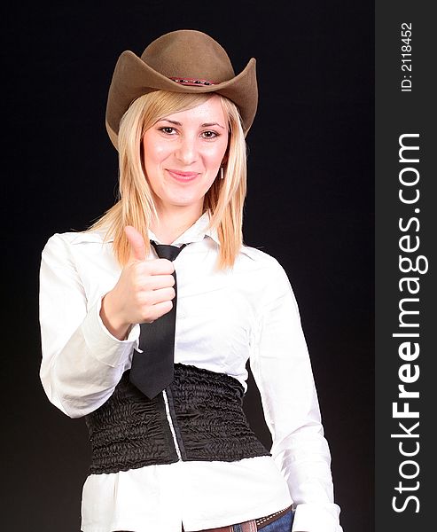 Beautiful sexy blonde cowgirl in studio with cowboy hat