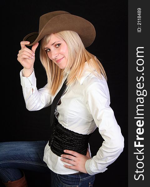 Beautiful blonde cowgirl in studio with cowboy hat