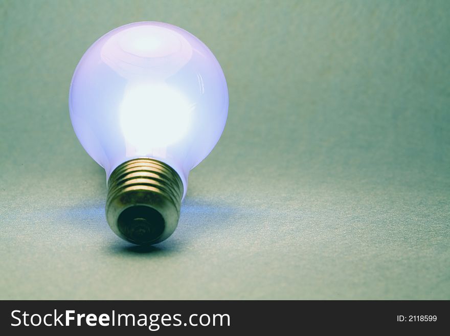 A shot of a glowing light bulb. A shot of a glowing light bulb