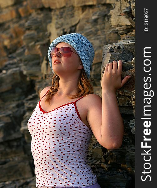 Young attractive woman posing on the cliffs