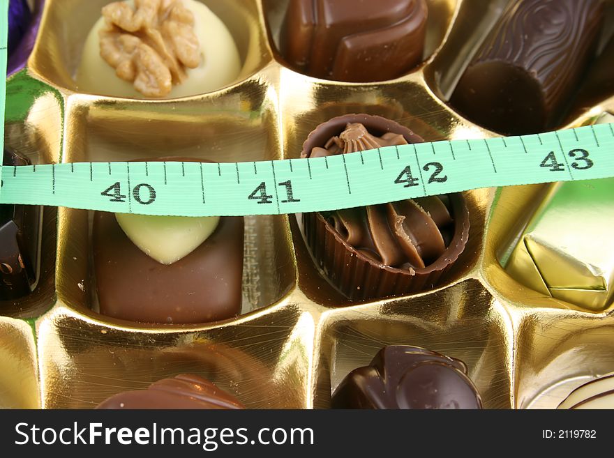 Close up of Luxury Chocolates with tape measure. Close up of Luxury Chocolates with tape measure