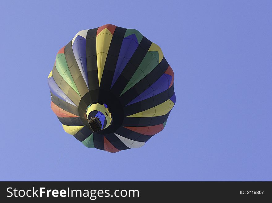 A colorful hot air balloon in flight taken from the ground