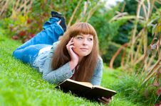 Young Woman Reading A Book Lying On The Grass Royalty Free Stock Image Young Woman Reading A Book Lying On The Grass Royalty Free Stock Image