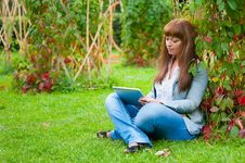 Young Woman Reading In Tablet Pc Stock Photo Young Woman Reading In Tablet Pc Stock Photo