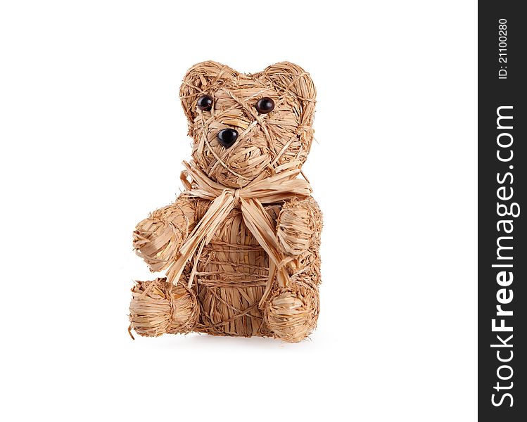 Small Toy bear from straw on white.