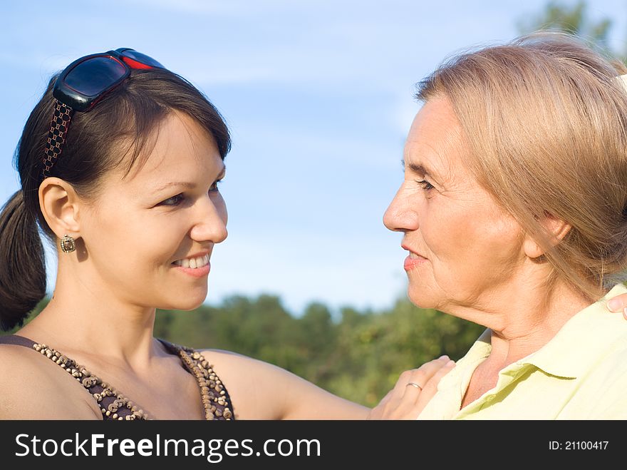 Cute mom and her adult daughter at nature. Cute mom and her adult daughter at nature