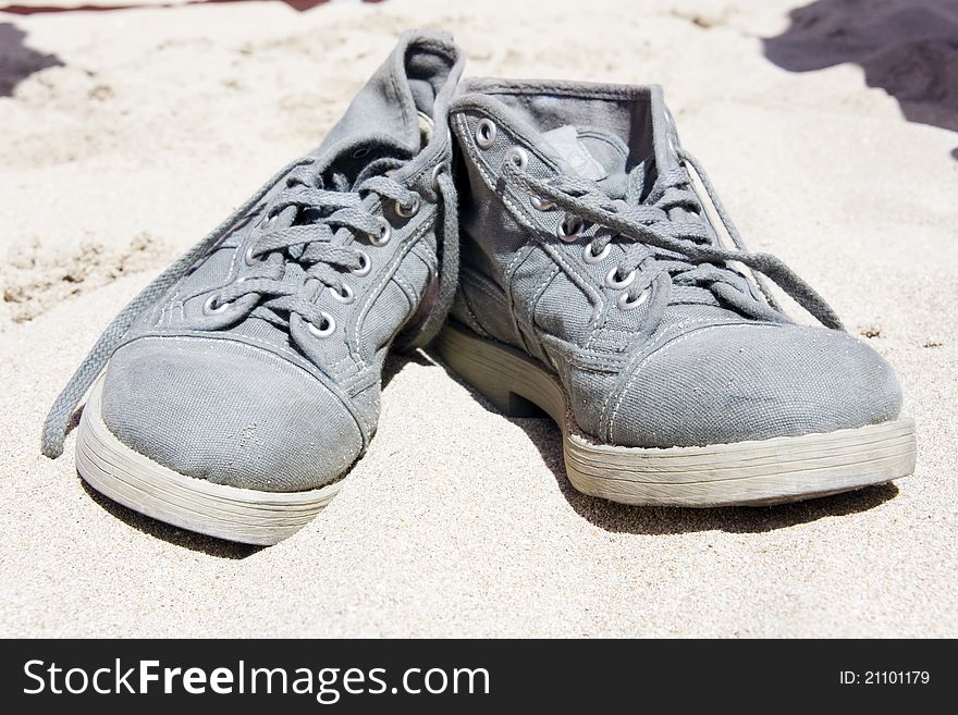 Shoes on the sand can be used as a background