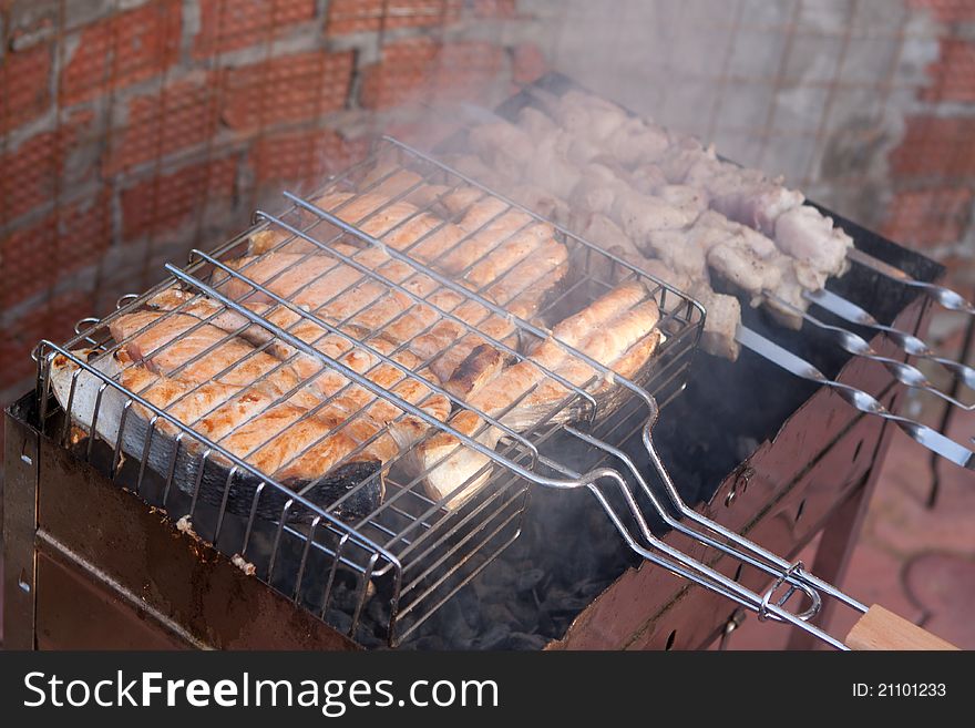 Shish kebab from a salmon on a lattice in the garden