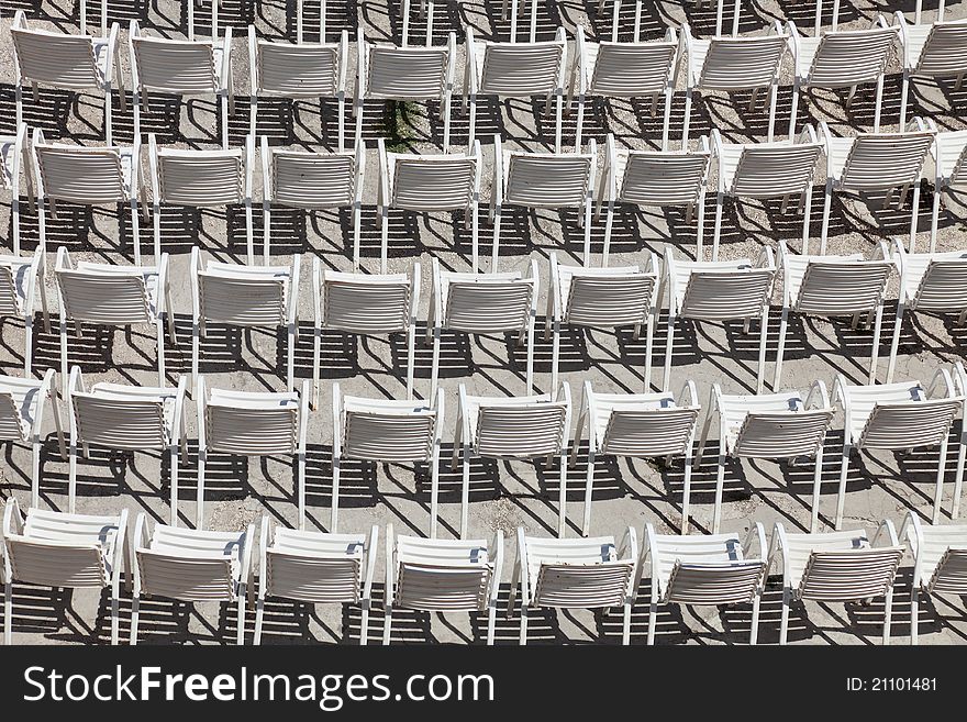 White plastic chairs set for an outdoor event. White plastic chairs set for an outdoor event.