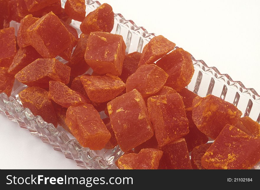 Close-up of dehydrated orange papaya fruit, bite-size pieces in a long narrow glass dish ready for a healthy snack. Close-up of dehydrated orange papaya fruit, bite-size pieces in a long narrow glass dish ready for a healthy snack.