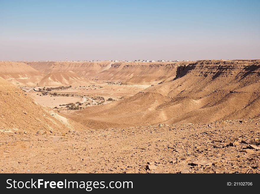 A village which overhangs a cliff in the desert. A village which overhangs a cliff in the desert