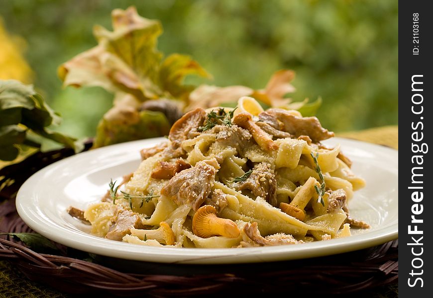 Tagliatelle with chanterelle, parmesan and thyme. Selective focus. Tagliatelle with chanterelle, parmesan and thyme. Selective focus