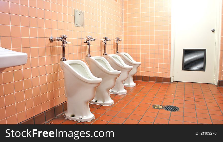 Row of unique urinals in a public toilet