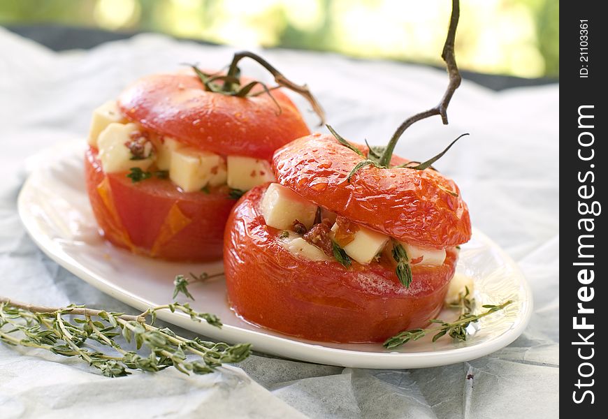 Stuffed tomatoes with cheese. Shallow DOF, selective focus .