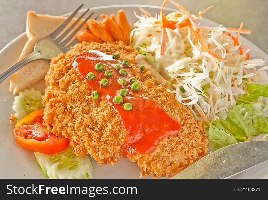 Fried fish with sauce and fresh vegetables salad. Fried fish with sauce and fresh vegetables salad