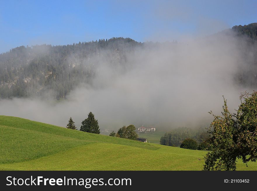 Fog over the landscape with mouintans behind, Walchsee in Austria. Fog over the landscape with mouintans behind, Walchsee in Austria