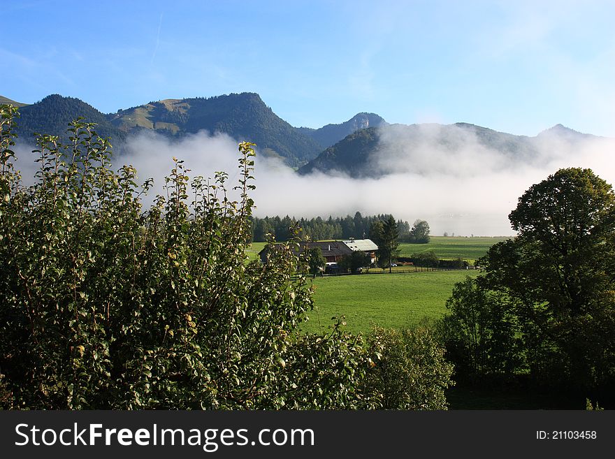 Fog over the landscape with mouintans behind, Walchsee in Austria. Fog over the landscape with mouintans behind, Walchsee in Austria