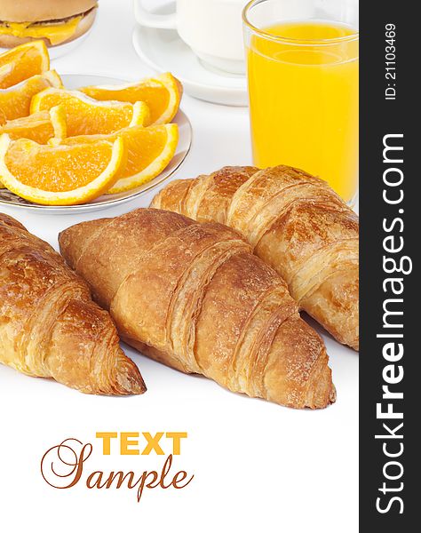 Croissant bun with orange juice on white background with text sample