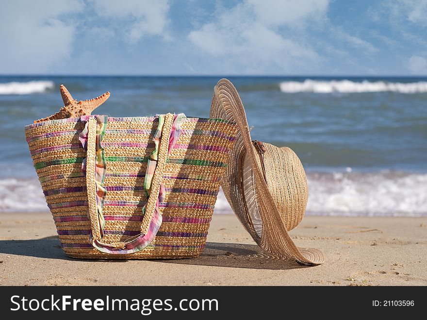 Women's hat and bag on the beach. Women's hat and bag on the beach