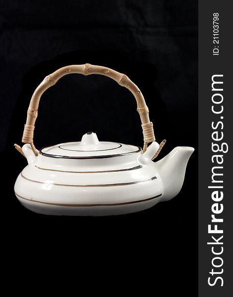 White teapot on black background. White teapot on black background