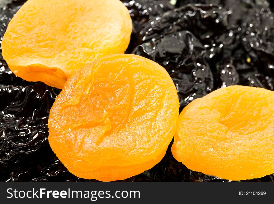 Some pieces of dried apricots lying on prunes (small depth of sharpness). Some pieces of dried apricots lying on prunes (small depth of sharpness)