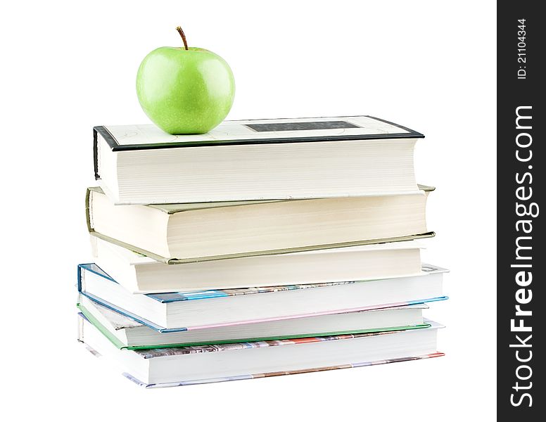 Green apple on textbooks on white background