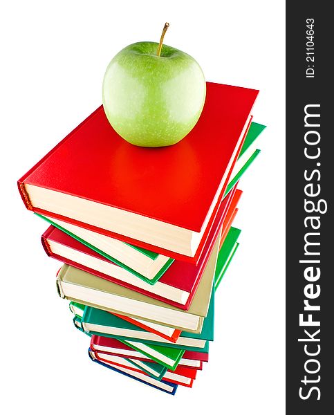 Stack of books with green apple on top on white background