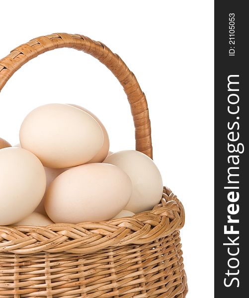 Eggs and basket on white background