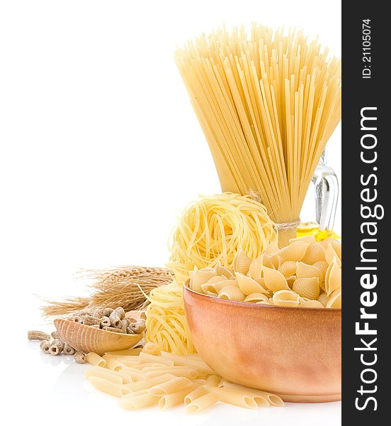 Pasta and wooden plate on white background
