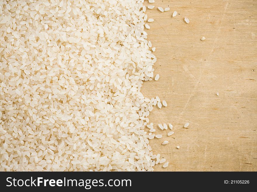 Rice grain and wood background