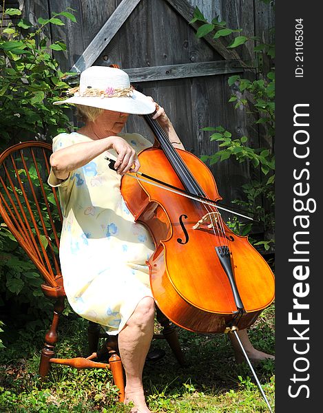 Female cellist performing with her cello outside. Female cellist performing with her cello outside.